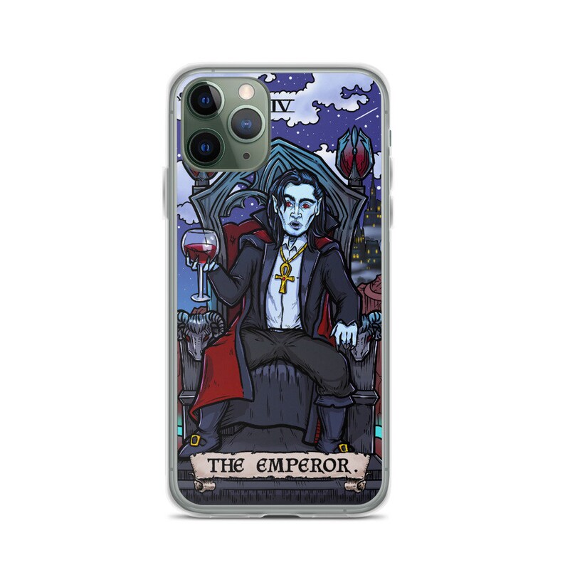 May include: A phone case featuring a colourful illustration of a vampire seated on a throne, holding a glass of wine. The illustration is in the style of a tarot card, with the text "THE EMPEROR" at the bottom.