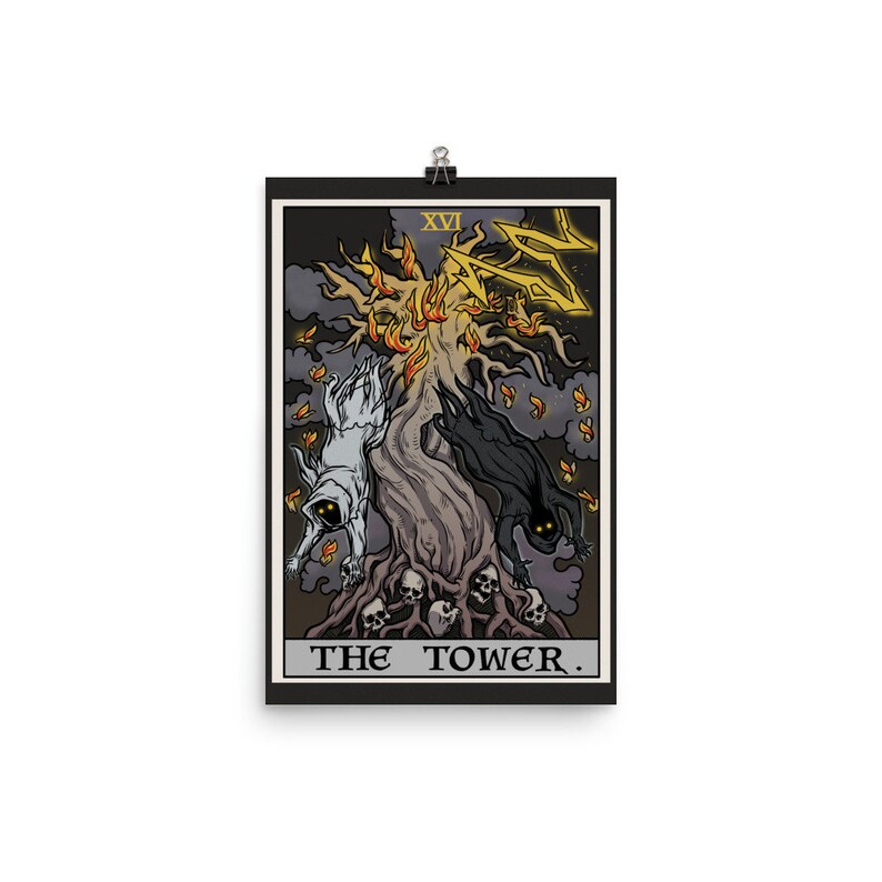 May include: A tarot card illustration of The Tower card. The card depicts a tall, dark tree with flames at the top. Two figures, one white and one black, are falling from the tree. The card number, XVI, is in the top left corner. The text "THE TOWER." is at the bottom of the card.