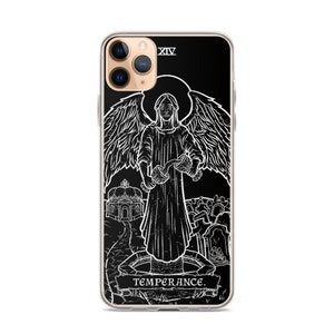 May include: Black and white illustration of the Temperance card from a tarot deck. The card features an angel pouring water from two cups, with a background of a church and a graveyard. The card number XIV is in the top right corner, and the word TEMPERANCE is at the bottom.