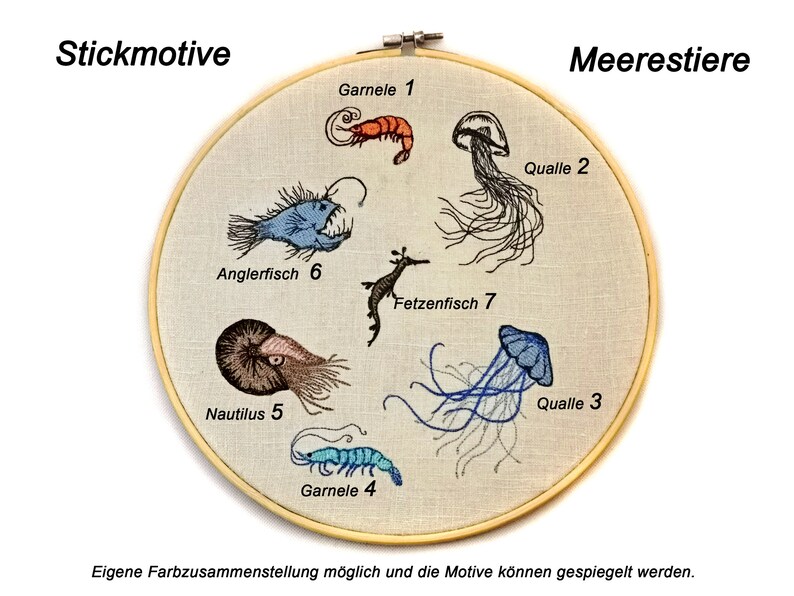 May include: Embroidered hoop art featuring sea creatures, including a blue anglerfish, a brown nautilus, a seahorse, and three jellyfish. The hoop is labeled "Stickmotive" and "Meerestiere" in German.