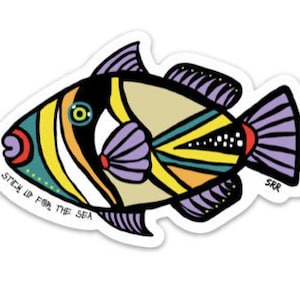 May include: A colorful sticker of a triggerfish with the text "Stick Up For The Sea". The fish is yellow, white, green, blue, orange, and purple.