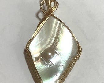 Diamond Shaped White American Dome Pearl pendant set in gold. Rare old stock from the Latendresse Pearl Farm in Tenn. Rainbow iridescent