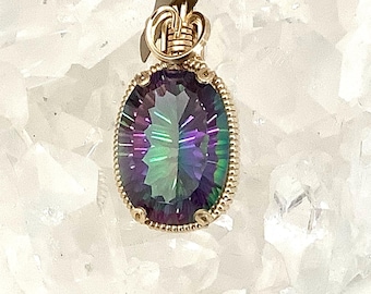 May include: A gold wire wrapped pendant featuring a large oval-shaped iridescent gemstone with a rainbow of colors, including purple, green, and blue.