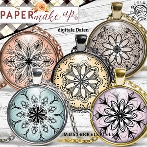 Puede incluir: Cuatro colgantes redondos de vidrio con diseños de mandalas en blanco y negro. Los colgantes están en cadenas plateadas, doradas y marrones. Los colgantes están sobre un fondo de madera blanco. El texto "PAPERmake up" y "digitale Daten" es visible en la imagen.