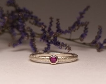 Silver engagement ring with red ruby