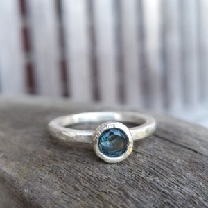 Silver engagement ring with dark blue topaz image 1