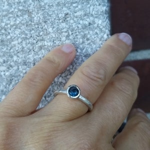 Silver engagement ring with dark blue topaz image 4