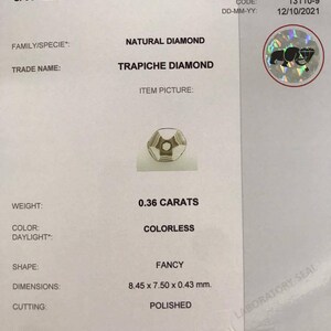 May include: A gemstone identification report for a 0.36 carat colorless natural diamond. The diamond is a trapiche diamond, a rare type of diamond with a star-shaped pattern. The report includes the diamond's weight, color, shape, dimensions, and cutting.