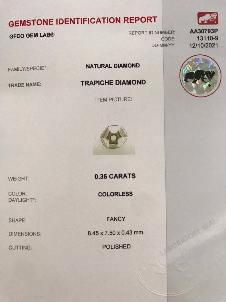 May include: A gemstone identification report for a 0.36 carat colorless natural diamond. The diamond is a trapiche diamond, a rare type of diamond with a star-shaped pattern. The report includes the diamond's weight, color, shape, dimensions, and cutting.