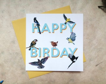 May include: A square greeting card with a white background featuring the text HAPPY BIRDAY in light blue letters with orange outlines. The card is decorated with illustrations of various birds including a magpie, goldfinch, wren, and blue tit.