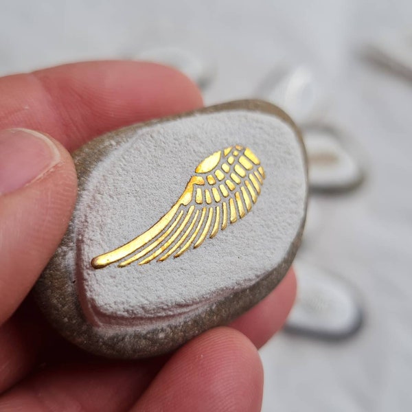 Guardian angel symbol, pebble with wings in silver, gold and bronze