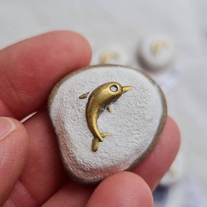 Small double, dolphin, lucky charm pebble with silver decorative element