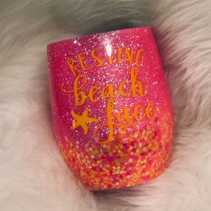May include: Pink glitter tumbler with a gold glitter bottom and the text "Resting Beach Face" in gold lettering.