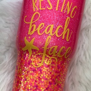 May include: Pink glitter tumbler with gold glitter accents and the text "Resting Beach Face" in gold lettering.