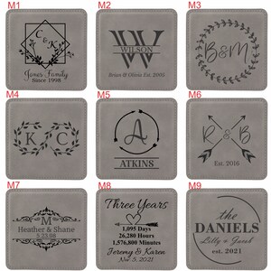May include: A set of nine square grey coasters, each featuring unique black laser-engraved designs including monograms, names, dates, and decorative elements like wreaths, arrows, and geometric frames, labelled M1 through M9 for customisation.