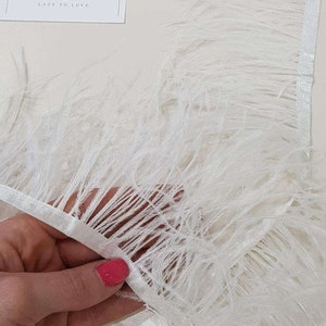 Light ivory natural ostrich feathers on a ribbon, MC003