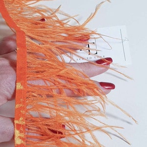 Orange natural ostrich feathers on a ribbon, MC040