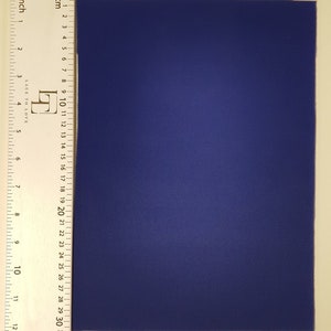 May include: A solid blue piece of fabric measuring approximately 14 inches by 18 inches.
