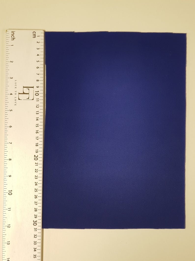 May include: A solid blue piece of fabric measuring approximately 14 inches by 18 inches.