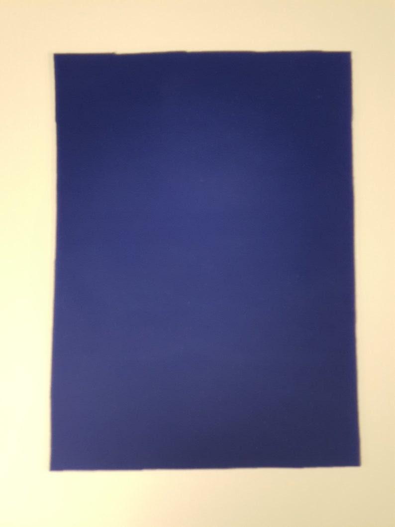 May include: A solid blue piece of felt fabric.