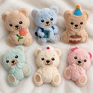 May include: Six plush teddy bear patches in various colours. Top row: a tan bear with a pink flower, a blue bear holding a book with ABC text, and a tan bear with a blue party hat and cake. Bottom row: a mint bear, a cream bear with a nurse cap, and a pink bear.