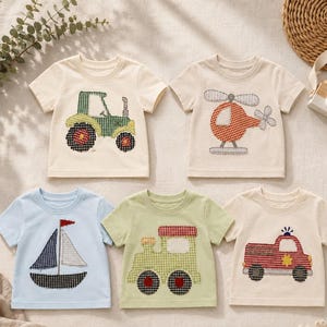 May include: A set of five short-sleeved t-shirts featuring gingham fabric appliqués of a green tractor, an orange helicopter, a blue sailboat, a light green train, and a red fire engine, all displayed on a neutral-coloured fabric surface.