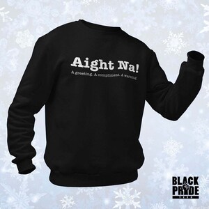 May include: Black sweatshirt with white text that reads "Aight Na! A greeting. A compliment. A warning."