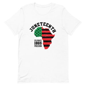 May include: White t-shirt with a black and red graphic of an outline of Africa with a green and red American flag design. The text "Juneteenth" is in a black arc above the graphic. The text "Celebrate 1865 Freedom" is below the graphic.