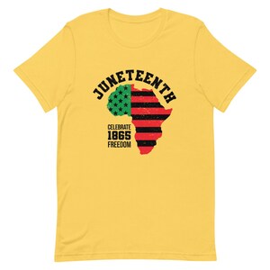 May include: Yellow t-shirt with a black and red graphic of an outline of Africa with a red, white, and blue American flag on the left side. The text "Juneteenth" is in a black arc above the graphic. The text "Celebrate 1865 Freedom" is below the graphic.