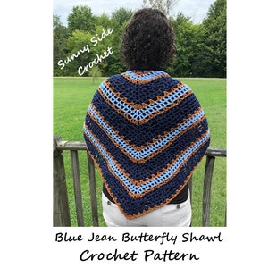 May include: A blue, brown, and light blue crochet shawl with a butterfly pattern. The shawl is being worn by a person with curly brown hair. The text "Sunny Side Crochet" is written in white on a blue background in the top left corner of the image. The text "Blue Jean Butterfly Shawl Crochet Pattern" is written in black at the bottom of the image.