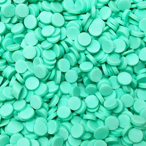 May include: A large quantity of small, round, turquoise-colored confetti.