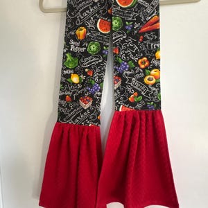 May include: A white ceramic mug with a black handle and the text "But First, Coffee" in a bold, black font. The mug is set against a blurred background, suggesting a cozy setting.