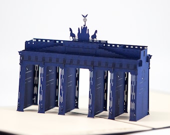 May include: A blue papercraft model of the Brandenburg Gate, a famous landmark in Berlin, Germany. The model features intricate details, including the Quadriga sculpture on top.