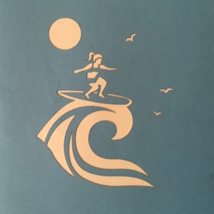 May include: A silhouette of a person surfing on a wave with a sun and birds in the background. The image is cut out of a light blue background.