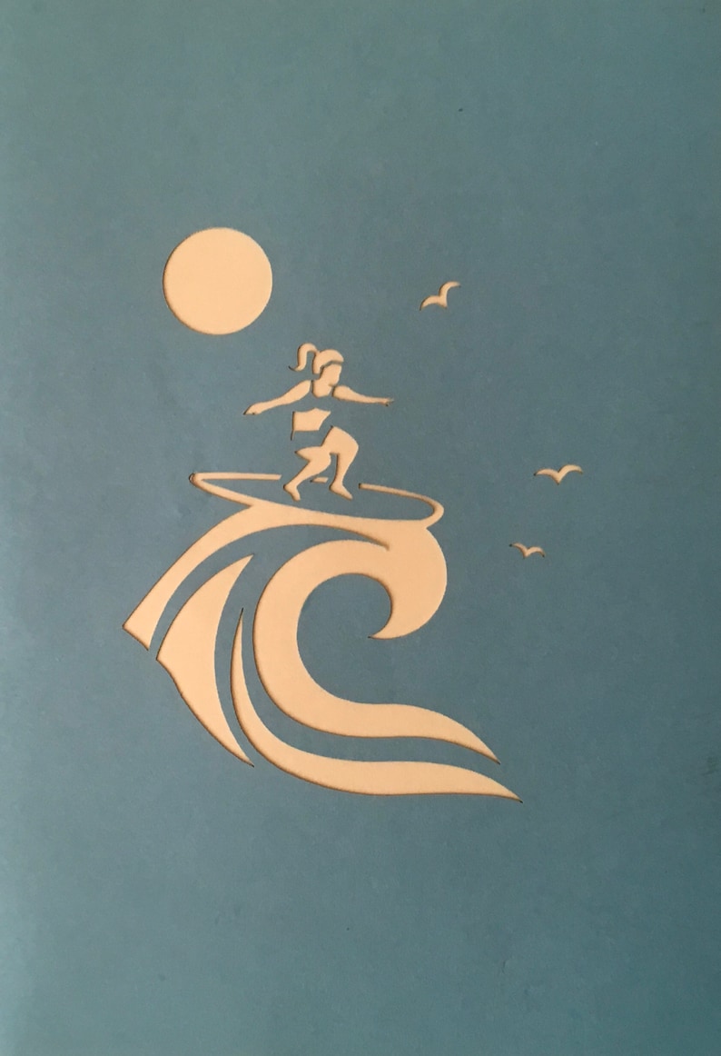 May include: A silhouette of a person surfing on a wave with a sun and birds in the background. The image is cut out of a light blue background.