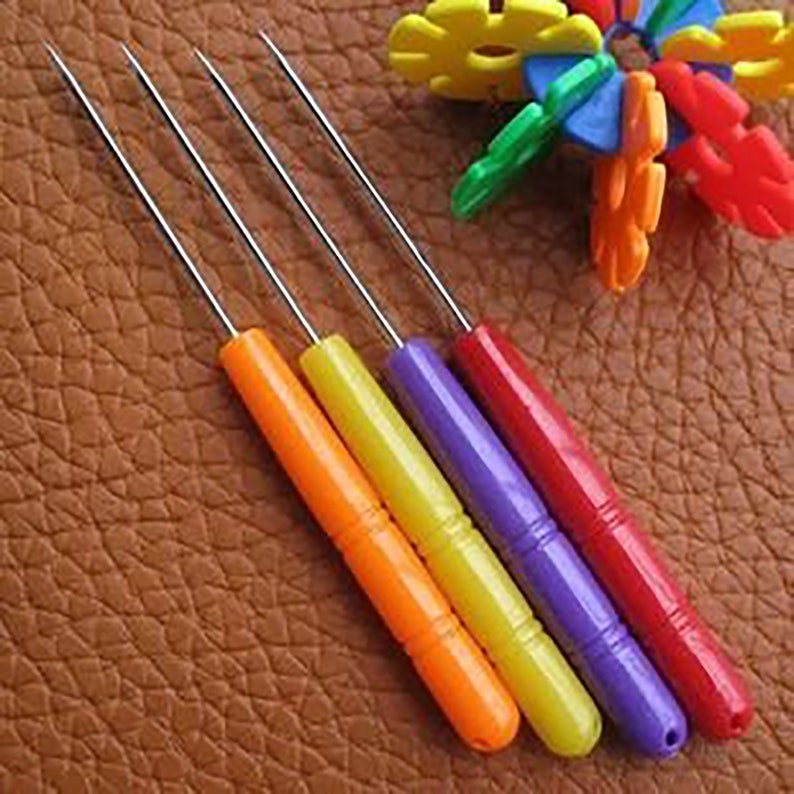 May include: Set of five colorful leather crafting tools with metal tips. The tools are orange, yellow, purple, and red.