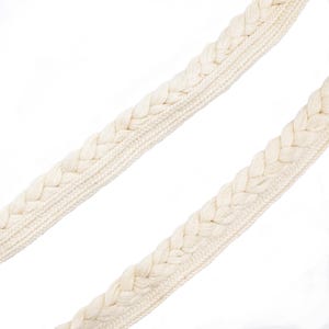May include: Two off-white, braided knit straps are diagonally positioned against a white background. The straps have a thick, textured appearance, with the braided sections creating a repeating pattern. The overall aesthetic is simple and clean.