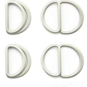 May include: Four silver-toned metal D-ring buckles. Each buckle is flat, oval shaped with a smaller, centred D-ring.