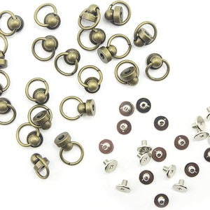 May include: A set of 20 antique gold-toned metal swivel snap hooks with a ball on the top. The set also includes 20 silver-toned metal screws and washers.