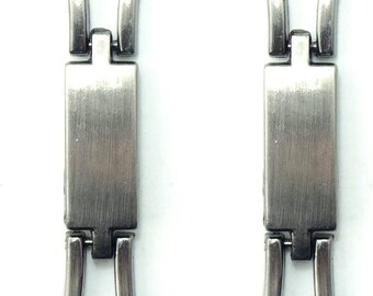 May include: Two silver watch band links with a brushed finish. Each link has a rectangular center section and two curved end sections.