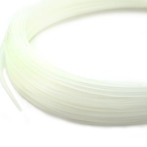 May include: A spool of white string, wound tightly in a coil.