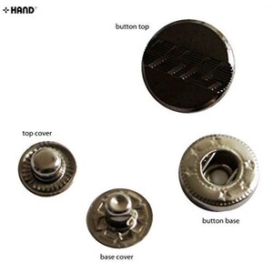 May include: A selection of metal snap fasteners, including a button top with a textured design, a top cover, a base cover, and a button base. The fasteners are in various sizes and shapes, suitable for clothing or craft projects.