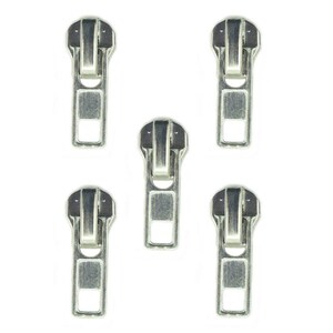 May include: Five silver metal zipper pulls against a white backdrop. Each pull features a rectangular body with a square aperture at the base and a curved top with a handle. The pulls are made of metal and have a shiny finish.