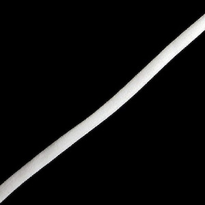 May include: A diagonal view of a white, textured elastic cord against a black background. The cord appears to be made of a soft, flexible material, and is angled from the lower left to the upper right.