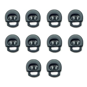 May include: Ten black plastic clasps with a spring mechanism. The clasps are designed to be used for attaching straps or cords to clothing or other items.