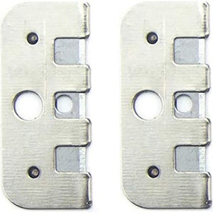 May include: Two silver metal plates with three cutouts each. The plates have a brushed finish and are designed for use with a tool.