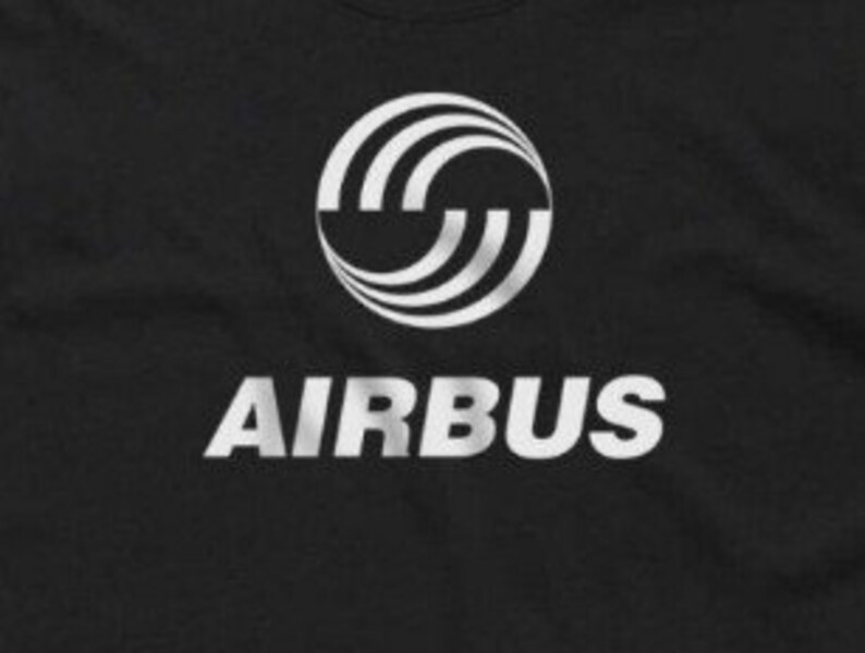 May include: A black t-shirt with a white graphic of the Airbus logo. The logo is a circle with three white curved lines inside. The word "AIRBUS" is printed in white below the logo.