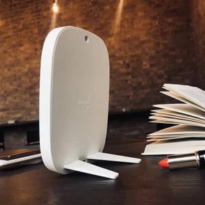 May include: White air purifier with a stand and the text "airfrange mini" on the front.