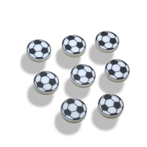 May include: Eight white round buttons with a black soccer ball design.