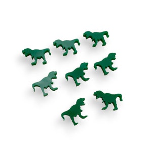 May include: Eight green plastic dinosaur figurines in various poses. The dinosaurs are all facing different directions and are scattered across a white background.